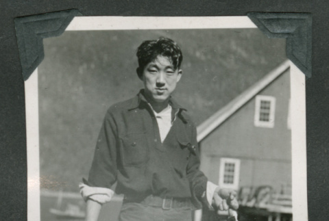 Man holding fish (ddr-densho-540-90)