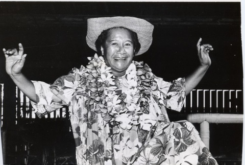 Man posing wearing leis and Hawaiian dress (ddr-njpa-2-383)