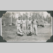 Six men posing for photo by tents (ddr-ajah-2-654)