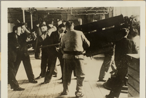 Men looking at an anti-aircraft gun (ddr-njpa-13-1327)