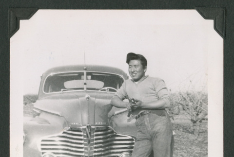 Man leaning against a car (ddr-densho-471-187)