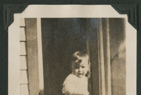 baby using a door (ddr-densho-378-571)