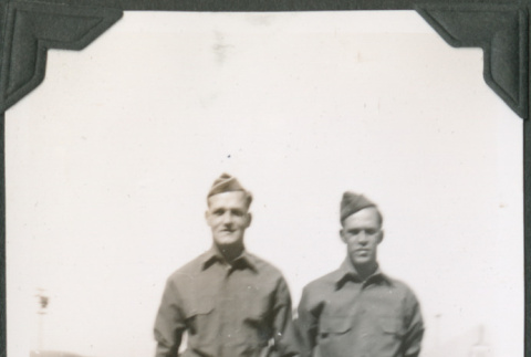 Two men in uniform standing on road (ddr-ajah-2-86)