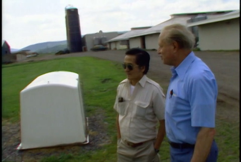 William Kochiyama and Robert H. Foote driving to and walking around a Cornell university farm (ddr-densho-1007-1518)