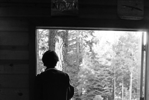 A camper standing in the doorway of the mess hall (ddr-densho-336-210)