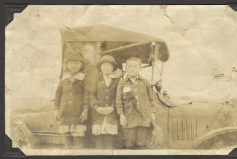 Three children next to car (ddr-densho-326-376)