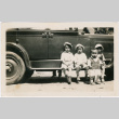 Four children sitting on running board of car (ddr-densho-458-106)