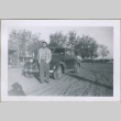 A man standing in front of a car (ddr-densho-300-37)