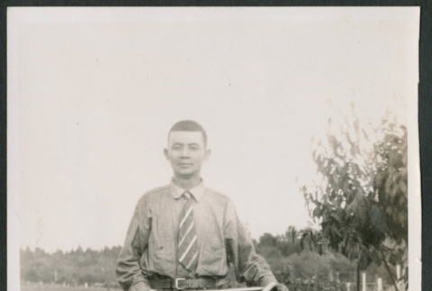 Photo of a man with a bicycle (ddr-densho-483-725)