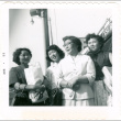 Four women outside holding bags (ddr-densho-430-218)