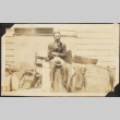 Man sitting on crates (ddr-densho-423-520)