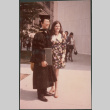 Man in graduation robe with woman (ddr-densho-523-521)