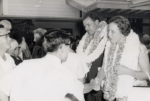 Couple wearing leis being welcomed at the Honolulu Airport (ddr-njpa-2-224)