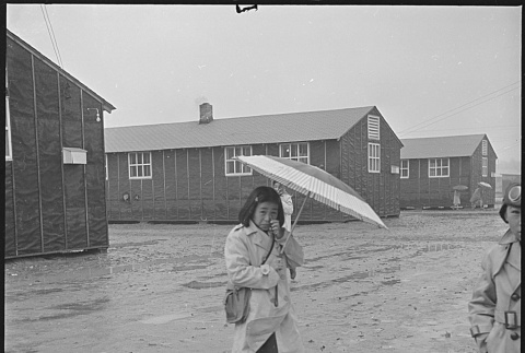 Japanese American walking in the rain (ddr-densho-37-617)
