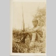 A young soldier seated with a rifle (ddr-njpa-6-20)