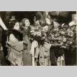 A man and woman being greeted with bouquets (ddr-njpa-1-1885)