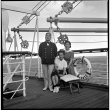 Man and two women on board ship (ddr-densho-426-259)
