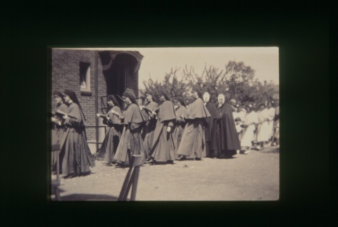 (Slide) - Image of procession of nuns outside building (ddr-densho-330-103-master-77cc1fdebc)