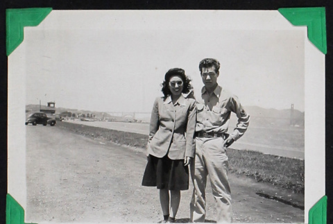 Man and woman pose in front of a bridge (ddr-densho-404-193)