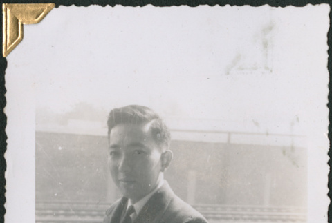 Man standing by railroad tracks (ddr-densho-434-286)
