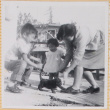 Yoshiko Shiomi with Susan and William Shiomi with puppy (ddr-densho-522-219)