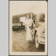 Woman and dog by car (ddr-densho-316-204)