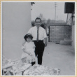 Man with girl in patio of house (ddr-densho-522-63)