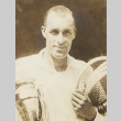 Bill Tilden holding a trophy and tennis rackets (ddr-njpa-1-2083)
