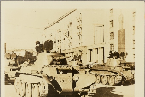 Soviet soldiers riding tanks on a city street (ddr-njpa-13-443)