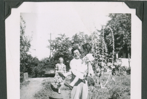 Three people in a garden (ddr-densho-471-176)