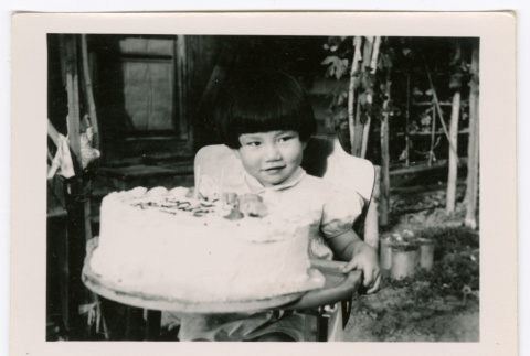 Young girl with cake (ddr-densho-475-355)