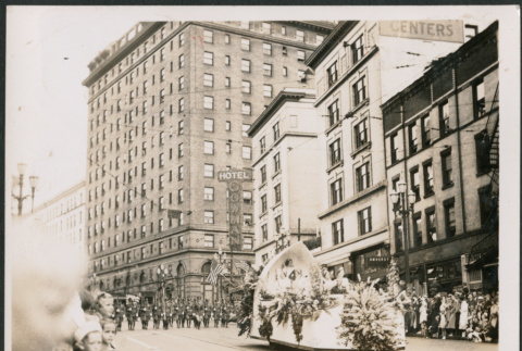 Parade float passing the Gowman Hotel in Seattle (ddr-densho-483-556)