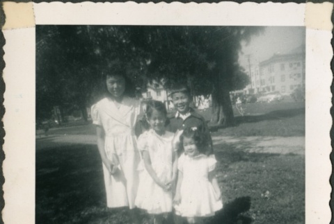 Group of 4 children stand on grass (ddr-densho-321-44)