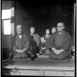 Family seated outside house (ddr-densho-426-309)