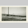 Photograph of a barracks at Manzanar with melting snow on the ground (ddr-csujad-47-335)