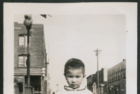 Photo of a child holding a purse (ddr-densho-483-718)