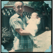 Walter Matsuoka holds up his infant son (ddr-densho-390-109)