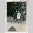 Young women standing in front of fence (ddr-densho-368-155)