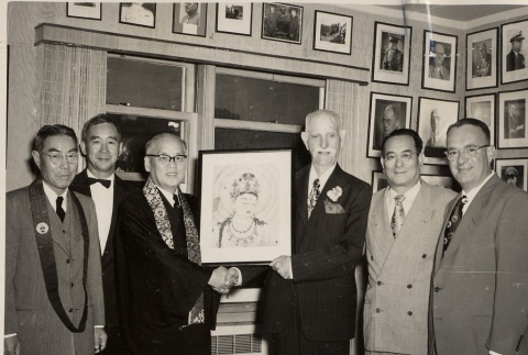 Buddhist priests and other men posing with a Buddha painting (ddr-njpa-2-639)