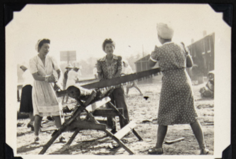 Women sawing firewood (ddr-densho-542-654)
