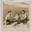 Henri Takahashi (l), unknown women and Tomoye (Nozawa) Takahashi sitting in a field (ddr-densho-426-1943)