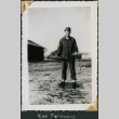 Man standing in field holding papers(?) (ddr-densho-434-330)