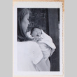 Photo of a woman holding a baby (ddr-densho-483-429)