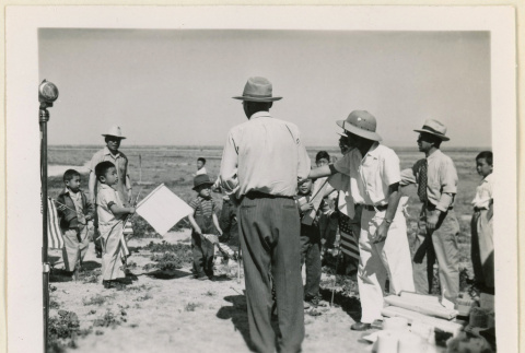 Group holding flags at a picnic (ddr-densho-37-1075)