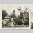 A family seated on rocks at the Mukai Garden on Vashon Island, Washington (ddr-densho-316-11)