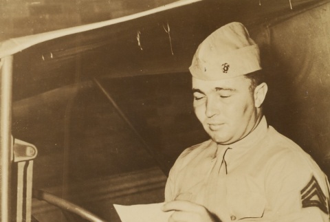 A soldier reading a letter in a truck (ddr-njpa-1-2062)