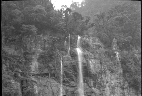 Tomoye (Nozawa) Takahashi standing by waterfall (ddr-densho-426-2414)