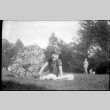 Young girl with parasol sitting in grass (ddr-densho-426-1819)