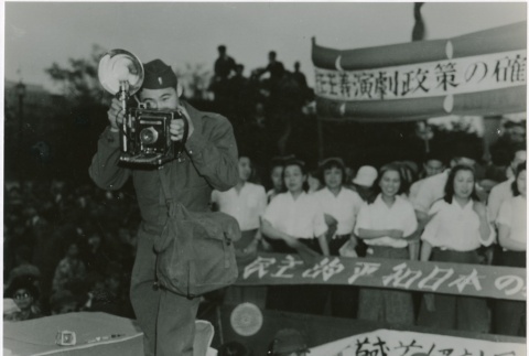Ted Akimoto taking a photograph (ddr-densho-299-144)