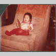 Girl with book in chair (ddr-densho-523-506)